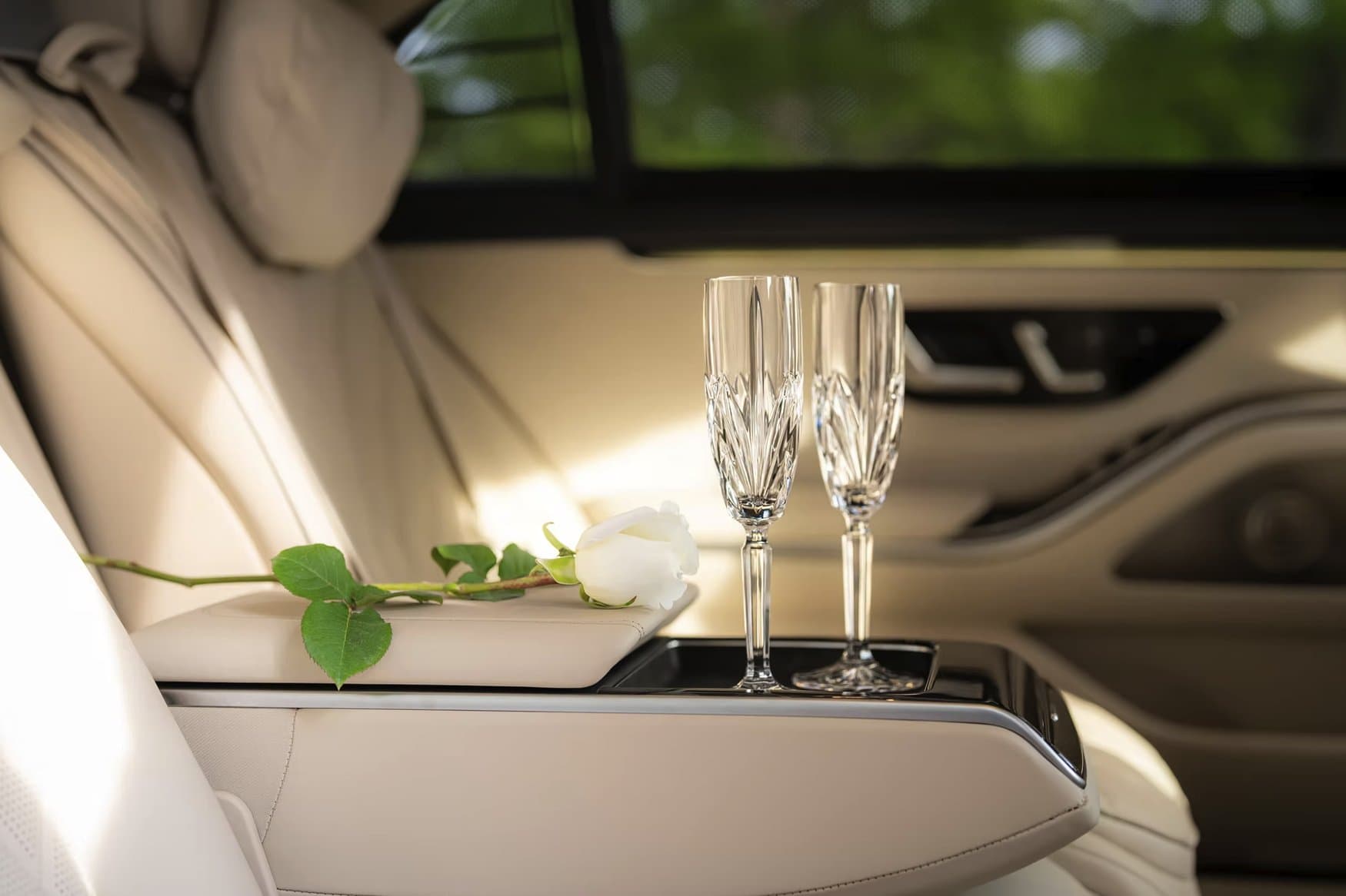 Chauffeur holding the rear door open at a Georgetown event for a Mercedes-Benz S580 arrival.