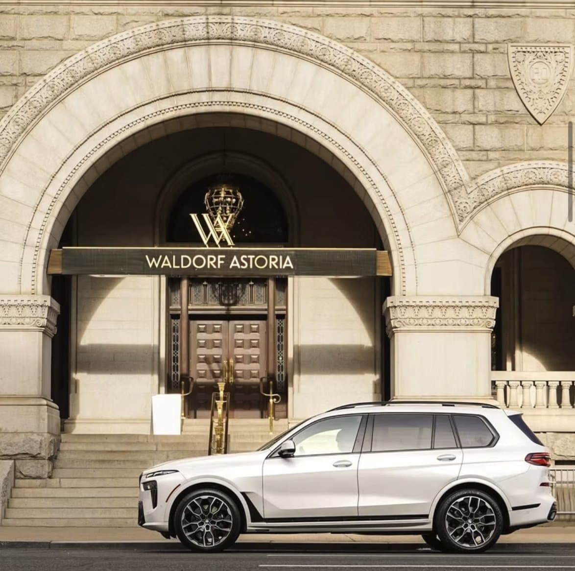 BMW X7 at IAD curbside meeting an international arrival.